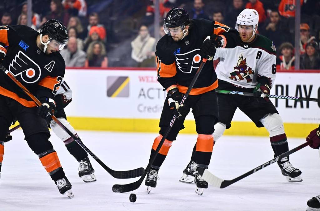 Feb 12, 2024; Philadelphia, Pennsylvania, USA; Philadelphia Flyers right wing Travis Konecny (11) reaches for a loose puck against the Arizona Coyotes in the third period at Wells Fargo Center. Mandatory Credit: Kyle Ross-USA TODAY Sports