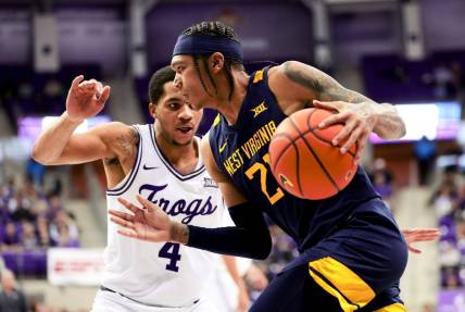 Feb 12, 2024; Fort Worth, Texas, USA;  West Virginia Mountaineers guard RaeQuan Battle (21) drives to the basket as TCU Horned Frogs guard Jameer Nelson Jr. (4) defends during the second half at Ed and Rae Schollmaier Arena. Mandatory Credit: Kevin Jairaj-USA TODAY Sports
