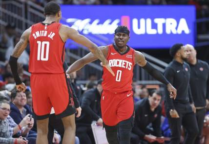 Feb 12, 2024; Houston, Texas, USA; Houston Rockets guard Aaron Holiday (0) celebrates with forward Jabari Smith Jr. (10) after a play during the fourth quarter against the New York Knicks at Toyota Center. Mandatory Credit: Troy Taormina-USA TODAY Sports