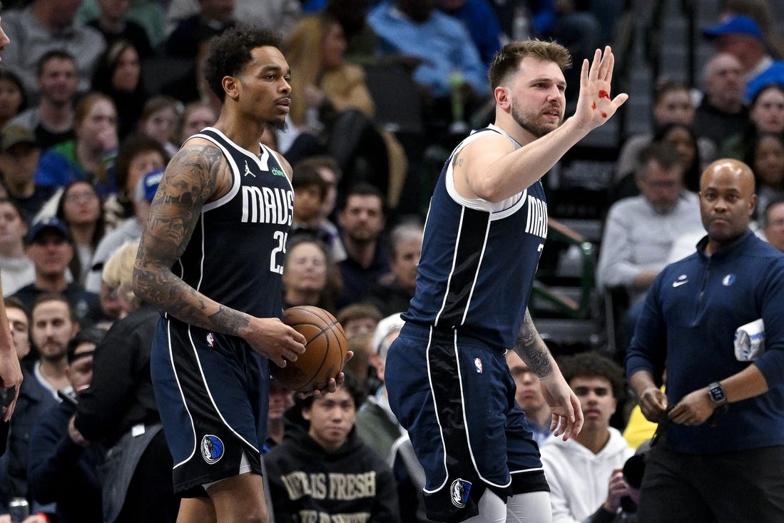 Feb 12, 2024; Dallas, Texas, USA; Dallas Mavericks guard Luka Doncic (77) shows blood on his hand after he is hit in the face by Washington Wizards forward Corey Kispert (not pictured) during the second half at the American Airlines Center. Mandatory Credit: Jerome Miron-USA TODAY Sports