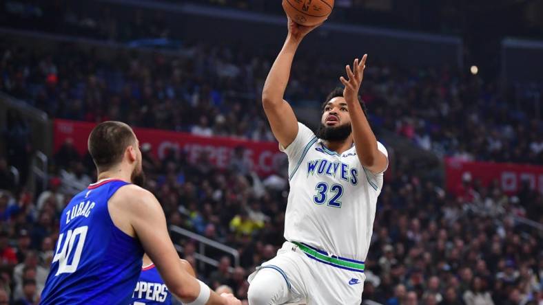 Feb 12, 2024; Los Angeles, California, USA; Minnesota Timberwolves center Karl-Anthony Towns (32) shoots against Los Angeles Clippers center Ivica Zubac (40) during the first half at Crypto.com Arena. Mandatory Credit: Gary A. Vasquez-USA TODAY Sports