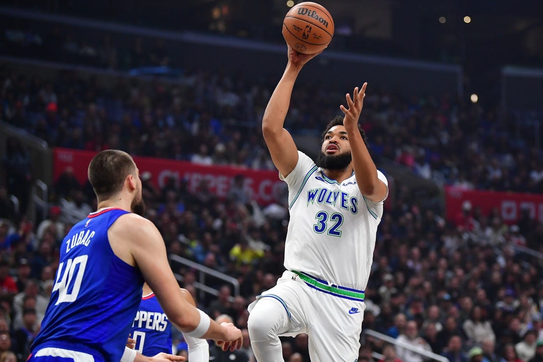 Feb 12, 2024; Los Angeles, California, USA; Minnesota Timberwolves center Karl-Anthony Towns (32) shoots against Los Angeles Clippers center Ivica Zubac (40) during the first half at Crypto.com Arena. Mandatory Credit: Gary A. Vasquez-USA TODAY Sports