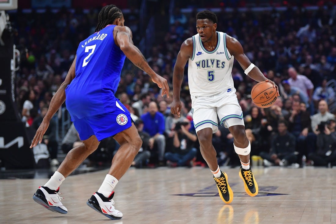 Feb 12, 2024; Los Angeles, California, USA; Minnesota Timberwolves guard Anthony Edwards (5) controls the ball against Los Angeles Clippers forward Kawhi Leonard (2) during the first half at Crypto.com Arena. Mandatory Credit: Gary A. Vasquez-USA TODAY Sports