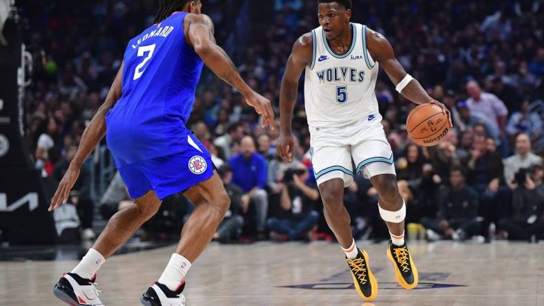 Feb 12, 2024; Los Angeles, California, USA; Minnesota Timberwolves guard Anthony Edwards (5) controls the ball against Los Angeles Clippers forward Kawhi Leonard (2) during the first half at Crypto.com Arena. Mandatory Credit: Gary A. Vasquez-USA TODAY Sports