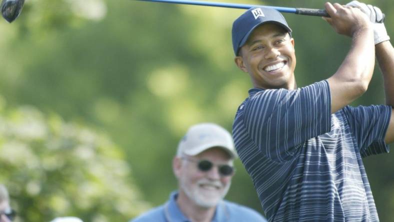 Tiger Woods was all smiles as he prepared to hit on the 13th tee at the Buick Open Pro-Am at Warwick Hills Golf and Country Club in Grand Blanc, Michigan on July 28, 2004.