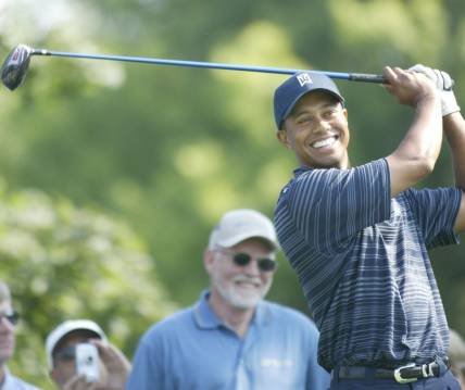 Tiger Woods was all smiles as he prepared to hit on the 13th tee at the Buick Open Pro-Am at Warwick Hills Golf and Country Club in Grand Blanc, Michigan on July 28, 2004.