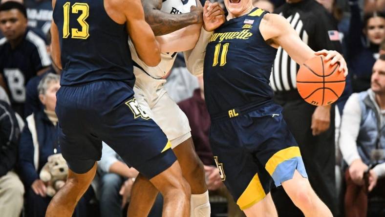 Feb 13, 2024; Indianapolis, Indiana, USA; Butler Bulldogs guard Jahmyl Telfort (11) fouls Marquette Golden Eagles guard Tyler Kolek (11) during the first half at Hinkle Fieldhouse. Mandatory Credit: Robert Goddin-USA TODAY Sports