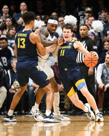Feb 13, 2024; Indianapolis, Indiana, USA; Butler Bulldogs guard Jahmyl Telfort (11) fouls Marquette Golden Eagles guard Tyler Kolek (11) during the first half at Hinkle Fieldhouse. Mandatory Credit: Robert Goddin-USA TODAY Sports