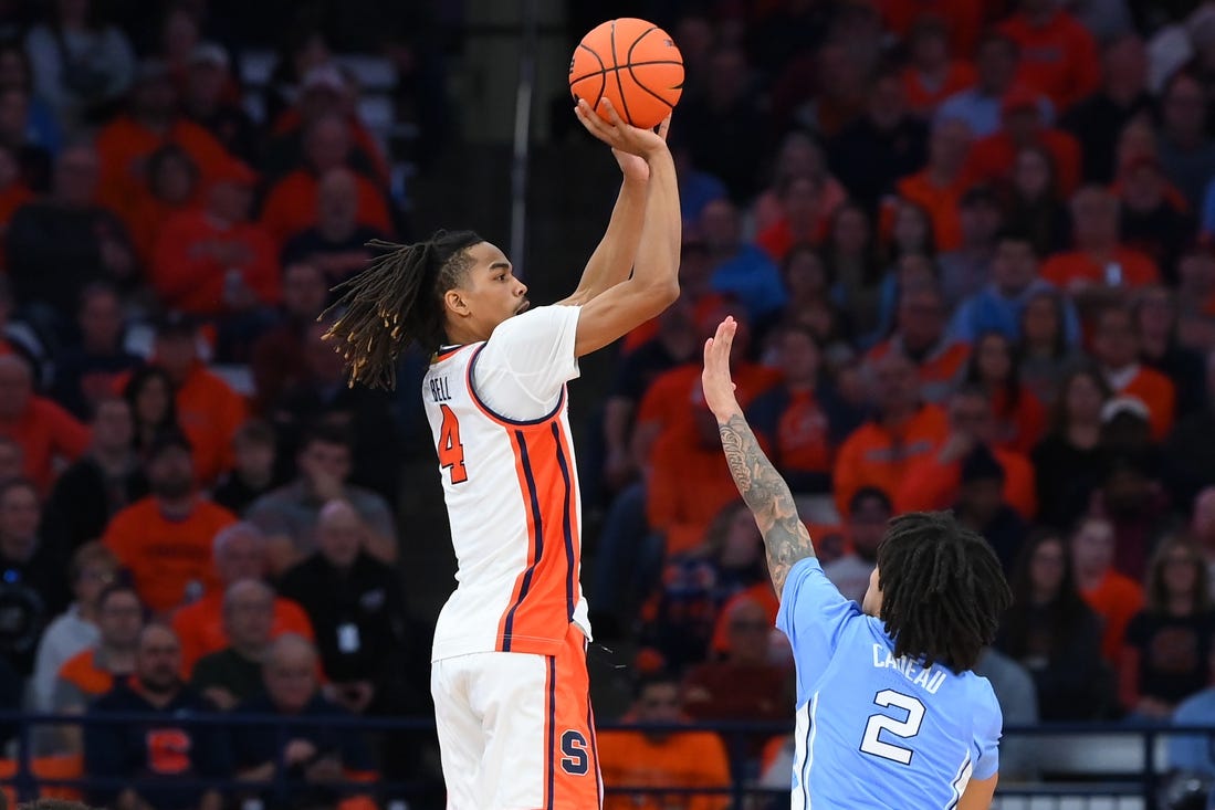 Feb 13, 2024; Syracuse, New York, USA; Syracuse Orange forward Chris Bell (4) shoots the ball against the defense of North Carolina Tar Heels guard Elliot Cadeau (2) during the first half at the JMA Wireless Dome. Mandatory Credit: Rich Barnes-USA TODAY Sports