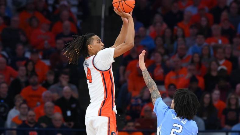 Feb 13, 2024; Syracuse, New York, USA; Syracuse Orange forward Chris Bell (4) shoots the ball against the defense of North Carolina Tar Heels guard Elliot Cadeau (2) during the first half at the JMA Wireless Dome. Mandatory Credit: Rich Barnes-USA TODAY Sports