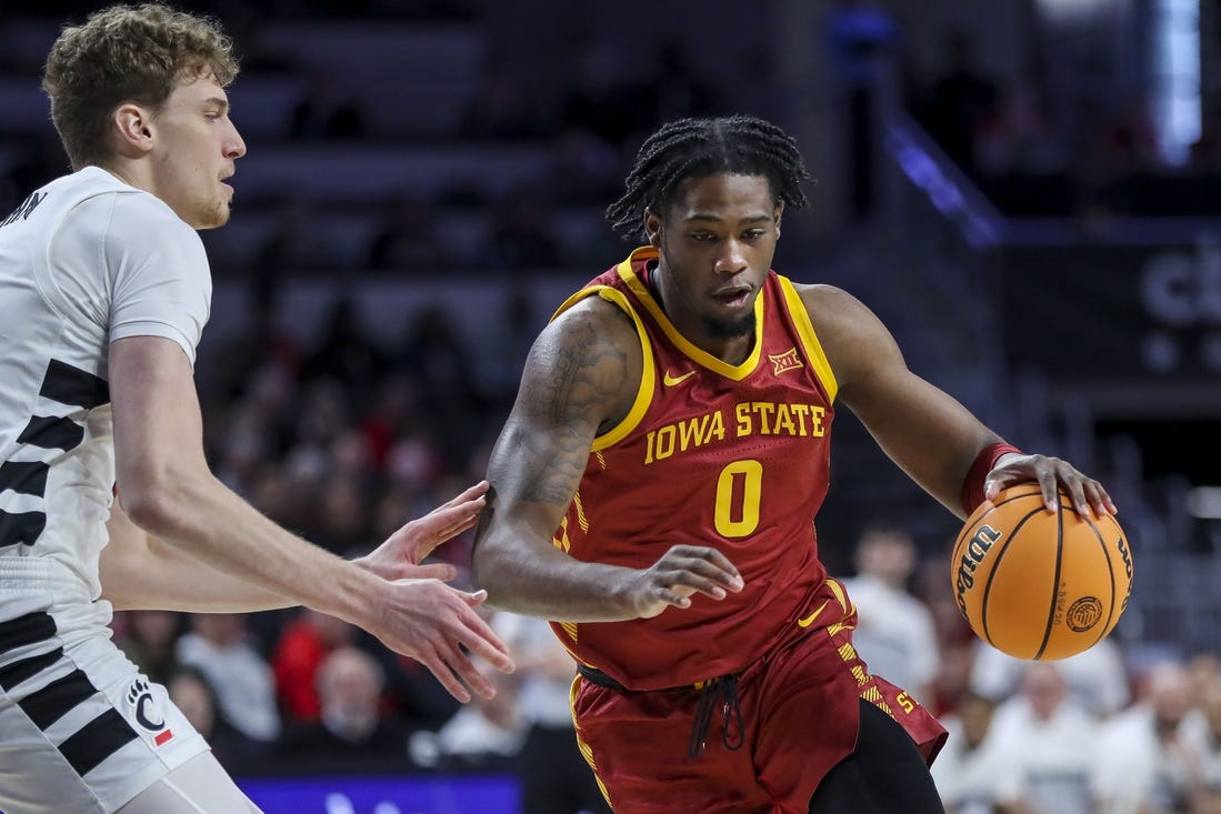 Feb 13, 2024; Cincinnati, Ohio, USA; Iowa State Cyclones forward Tre King (0) dribbles against Cincinnati Bearcats forward Viktor Lakhin (30) in the first half at Fifth Third Arena. Mandatory Credit: Katie Stratman-USA TODAY Sports