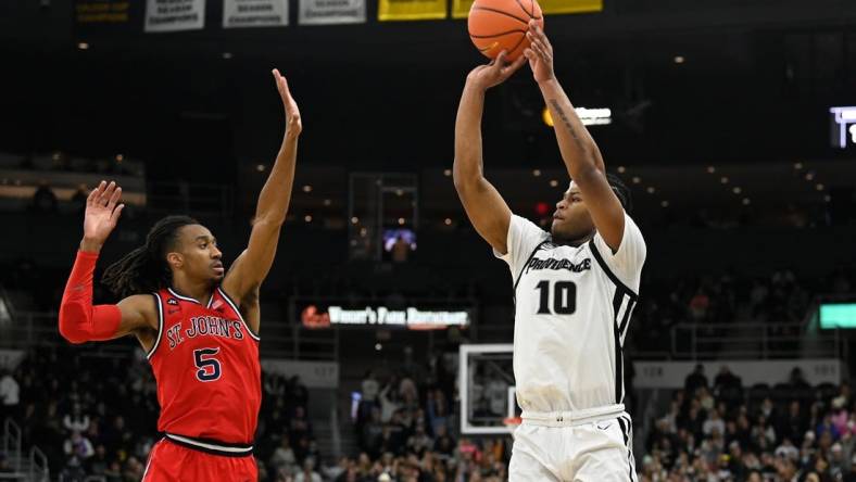 Feb 13, 2024; Providence, Rhode Island, USA; Providence Friars forward Rich Barron (10) shoots the ball over St. John's Red Storm guard Daniss Jenkins (5) during the first half at Amica Mutual Pavilion. Mandatory Credit: Eric Canha-USA TODAY Sports