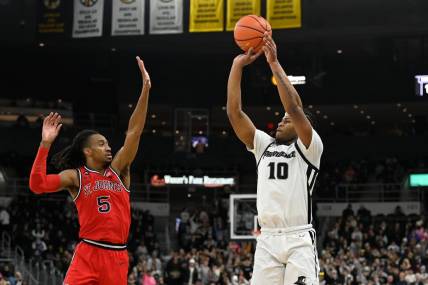 Feb 13, 2024; Providence, Rhode Island, USA; Providence Friars forward Rich Barron (10) shoots the ball over St. John's Red Storm guard Daniss Jenkins (5) during the first half at Amica Mutual Pavilion. Mandatory Credit: Eric Canha-USA TODAY Sports