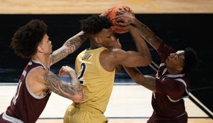 Vanderbilt Commodores forward Ven-Allen Lubin (2) is pressured by Texas A&M Aggies forward Andersson Garcia (11) and guard Wade Taylor IV (4) during their game at Memorial Gym in Nashville, Tenn., Tuesday, Feb. 13, 2024.