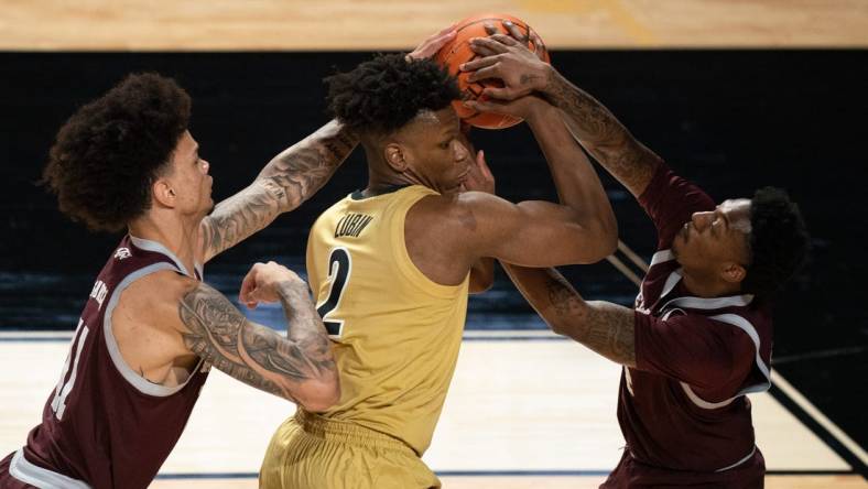 Vanderbilt Commodores forward Ven-Allen Lubin (2) is pressured by Texas A&M Aggies forward Andersson Garcia (11) and guard Wade Taylor IV (4) during their game at Memorial Gym in Nashville, Tenn., Tuesday, Feb. 13, 2024.