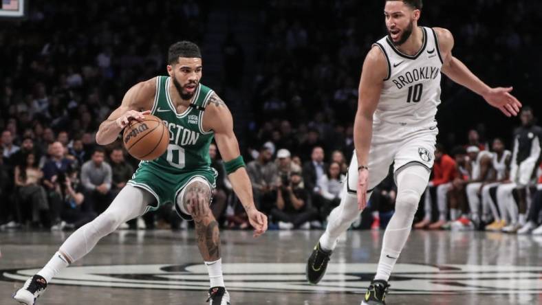 Feb 13, 2024; Brooklyn, New York, USA;  Boston Celtics forward Jayson Tatum (0) looks to drive past Brooklyn Nets guard Ben Simmons (10) in the second quarter at Barclays Center. Mandatory Credit: Wendell Cruz-USA TODAY Sports