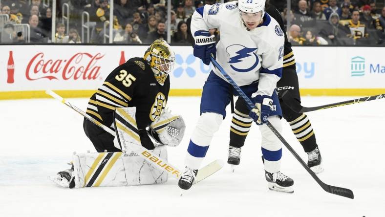 Feb 13, 2024; Boston, Massachusetts, USA; Tampa Bay Lightning center Michael Eyssimont (23) looks for the loose puck in front of Boston Bruins goaltender Linus Ullmark (35) during the second period at TD Garden. Mandatory Credit: Bob DeChiara-USA TODAY Sports