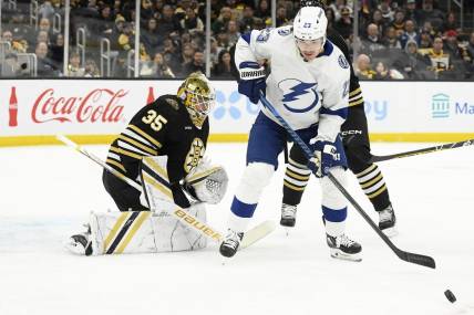 Feb 13, 2024; Boston, Massachusetts, USA; Tampa Bay Lightning center Michael Eyssimont (23) looks for the loose puck in front of Boston Bruins goaltender Linus Ullmark (35) during the second period at TD Garden. Mandatory Credit: Bob DeChiara-USA TODAY Sports