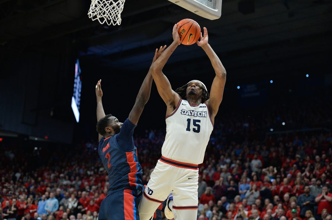 Feb 13, 2024; Dayton, Ohio, USA;  Dayton Flyers forward DaRon Holmes II (15) shoots the ball against Duquesne forward David Dixon (2) during the game at University of Dayton Arena. Mandatory Credit: Matt Lunsford-USA TODAY Sports