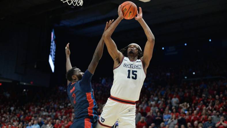 Feb 13, 2024; Dayton, Ohio, USA;  Dayton Flyers forward DaRon Holmes II (15) shoots the ball against Duquesne forward David Dixon (2) during the game at University of Dayton Arena. Mandatory Credit: Matt Lunsford-USA TODAY Sports