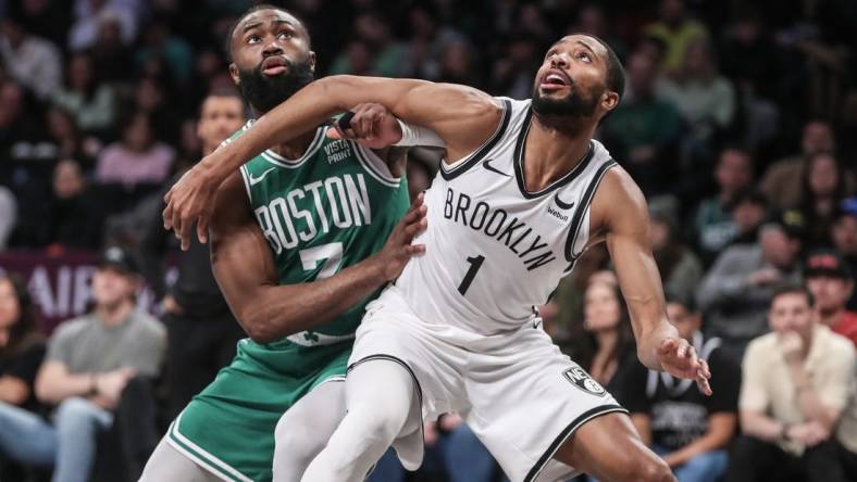 Feb 13, 2024; Brooklyn, New York, USA;  Boston Celtics guard Jaylen Brown (7) and Brooklyn Nets forward Mikal Bridges (1) box out for a rebound in the second quarter at Barclays Center. Mandatory Credit: Wendell Cruz-USA TODAY Sports