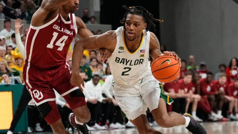 Feb 13, 2024; Waco, Texas, USA;  Baylor Bears guard Jayden Nunn (2) drives to the basket against Oklahoma Sooners forward Jalon Moore (14) during the second half at Paul and Alejandra Foster Pavilion. Mandatory Credit: Chris Jones-USA TODAY Sports