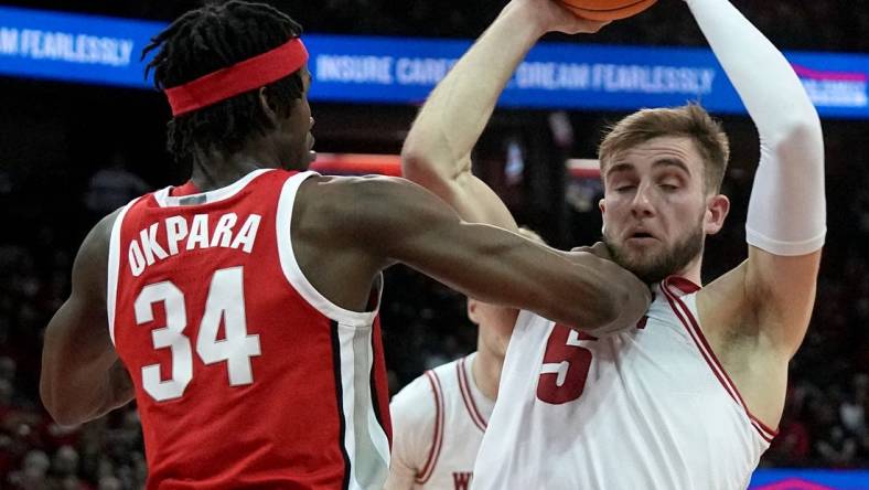 Feb 13, 2024; Madison, Wisconsin, USA;. Ohio State center Felix Okpara (34) grads Wisconsin forward Tyler Wahl (5) during the second half of their game at the Kohl Center. Mandatory Credit: Mark Hoffman/Milwaukee Journal Sentinelf-USA TODAY Sports