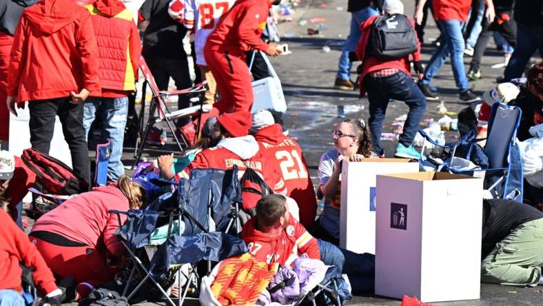 Feb 14, 2024; Kansas City, MO, USA; Fans shelter in place after shots were fired after the celebration of the Kansas City Chiefs winning Super Bowl LVIII. Mandatory Credit: David Rainey-USA TODAY Sports