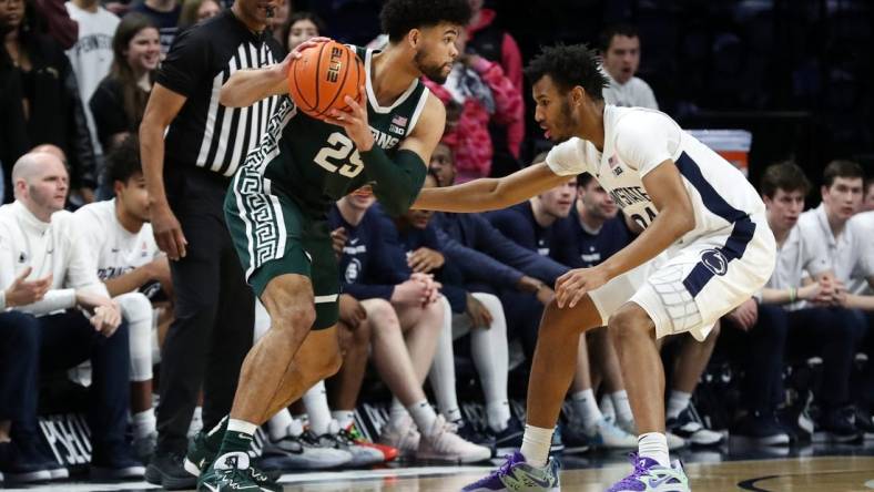 Feb 14, 2024; University Park, Pennsylvania, USA; Michigan State Spartans forward Malik Hall (25) holds the ball as Penn State Nittany Lions forward Zach Hicks (24) defends during the first half at Bryce Jordan Center. Mandatory Credit: Matthew O'Haren-USA TODAY Sports