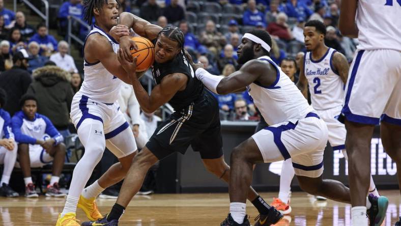 Feb 14, 2024; Newark, New Jersey, USA; Xavier Musketeers guard Quincy Olivari (8) is tied up by Seton Hall Pirates guard Dre Davis (14) and guard Dylan Addae-Wusu (0) during the first half at Prudential Center. Mandatory Credit: Vincent Carchietta-USA TODAY Sports