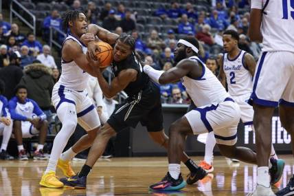 Feb 14, 2024; Newark, New Jersey, USA; Xavier Musketeers guard Quincy Olivari (8) is tied up by Seton Hall Pirates guard Dre Davis (14) and guard Dylan Addae-Wusu (0) during the first half at Prudential Center. Mandatory Credit: Vincent Carchietta-USA TODAY Sports