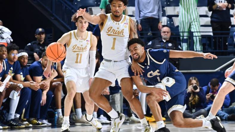 Feb 14, 2024; South Bend, Indiana, USA; Georgia Tech Yellow Jackets guard Kyle Sturdivant (1) knocks the ball away from Notre Dame Fighting Irish guard Julian Roper II (1) in the first half at the Purcell Pavilion. Mandatory Credit: Matt Cashore-USA TODAY Sports