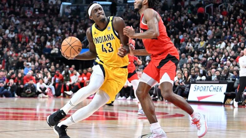 Feb 14, 2024; Toronto, Ontario, CAN;  Indiana Pacers forward Pascal Siakam (43) drives to the basket against Toronto Raptors guard Immanuel Quickley (5) in the first half at Scotiabank Arena. Mandatory Credit: Dan Hamilton-USA TODAY Sports