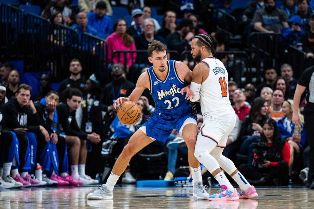 Feb 14, 2024; Orlando, Florida, USA; Orlando Magic forward Franz Wagner (22) dribbles the ball against New York Knicks guard Jalen Brunson (11) in the second quarter at KIA Center. Mandatory Credit: Jeremy Reper-USA TODAY Sports