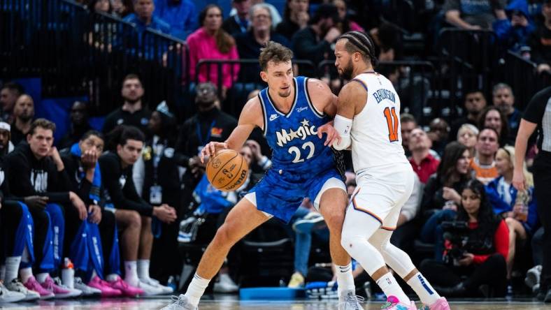 Feb 14, 2024; Orlando, Florida, USA; Orlando Magic forward Franz Wagner (22) dribbles the ball against New York Knicks guard Jalen Brunson (11) in the second quarter at KIA Center. Mandatory Credit: Jeremy Reper-USA TODAY Sports