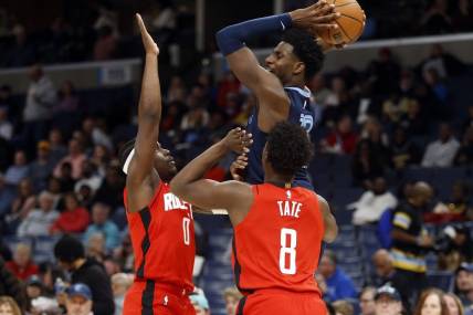 Feb 14, 2024; Memphis, Tennessee, USA; Memphis Grizzlies forward-center Jaren Jackson Jr. (13) passes the ball as Houston Rockets guard Aaron Holiday (0) and forward Jae'Sean Tate (8) defend during the first half at FedExForum. Mandatory Credit: Petre Thomas-USA TODAY Sports
