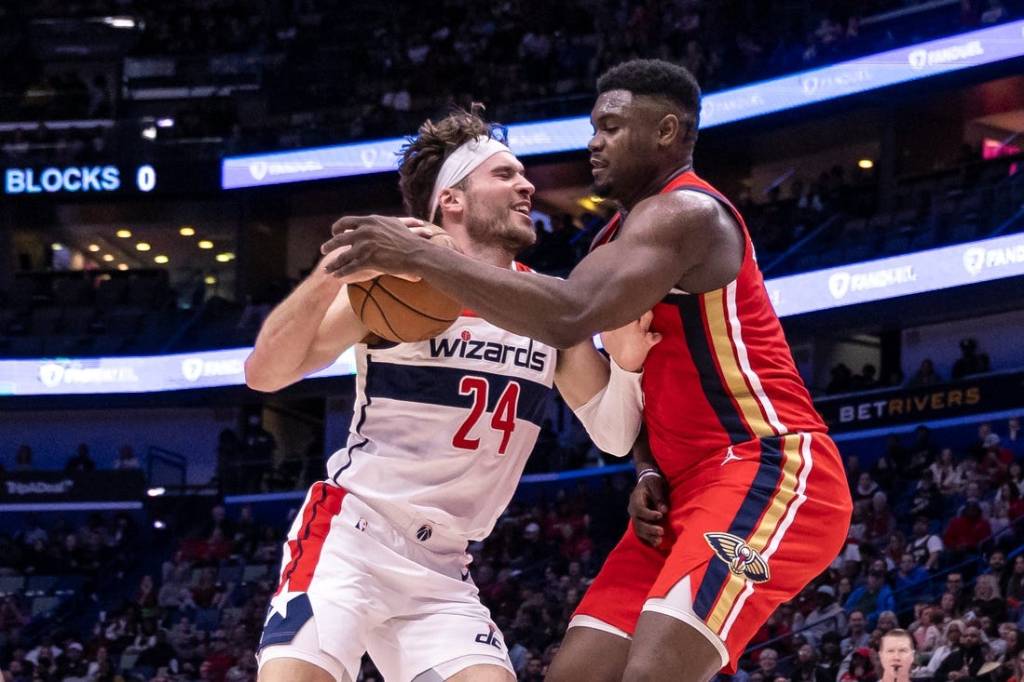 Feb 14, 2024; New Orleans, Louisiana, USA;  Washington Wizards forward Corey Kispert (24) dribbles against New Orleans Pelicans forward Zion Williamson (1) during the first half at Smoothie King Center. Mandatory Credit: Stephen Lew-USA TODAY Sports