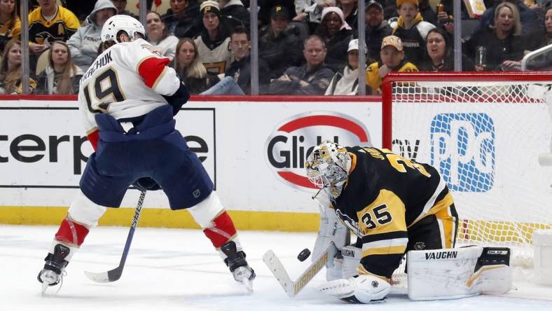 Feb 14, 2024; Pittsburgh, Pennsylvania, USA; Pittsburgh Penguins goaltender Tristan Jarry (35) makes a save against Florida Panthers left wing Matthew Tkachuk (19) during the second period at PPG Paints Arena. Mandatory Credit: Charles LeClaire-USA TODAY Sports