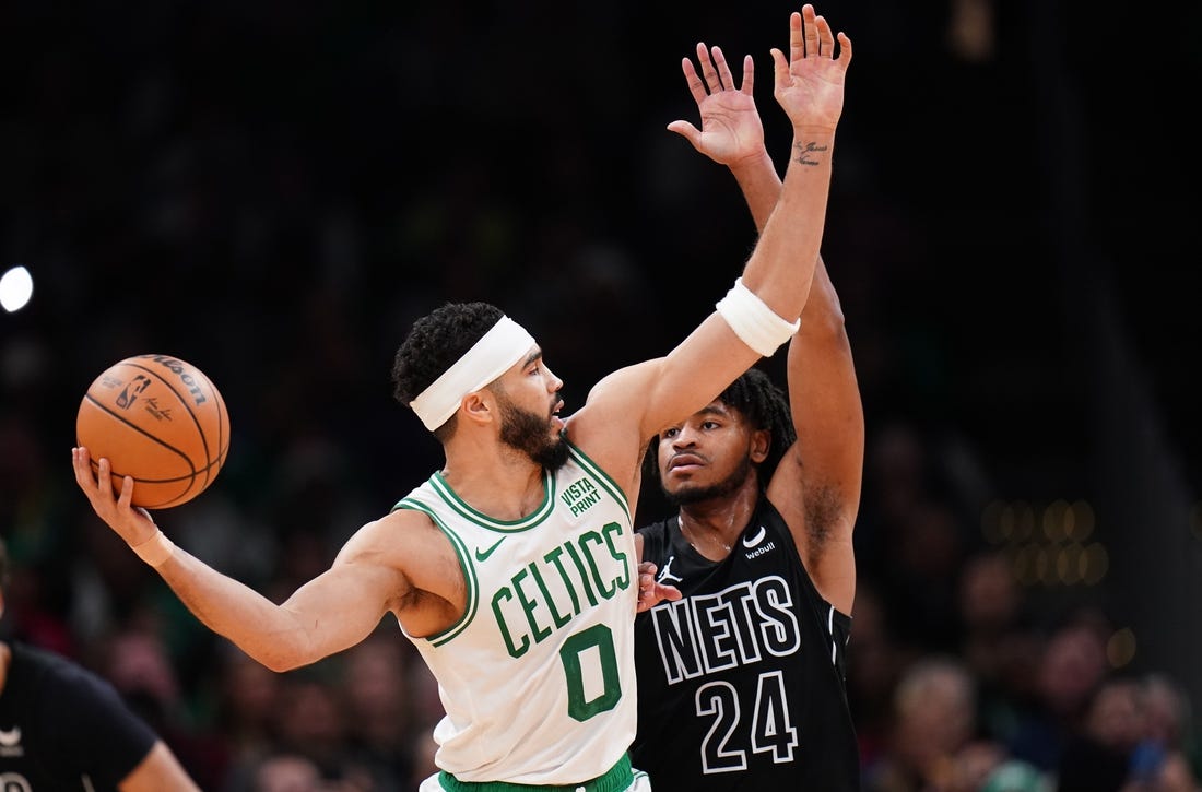 Feb 14, 2024; Boston, Massachusetts, USA; Boston Celtics forward Jayson Tatum (0) looks for an opening against Brooklyn Nets guard Cam Thomas (24) in the second half at TD Garden. Mandatory Credit: David Butler II-USA TODAY Sports