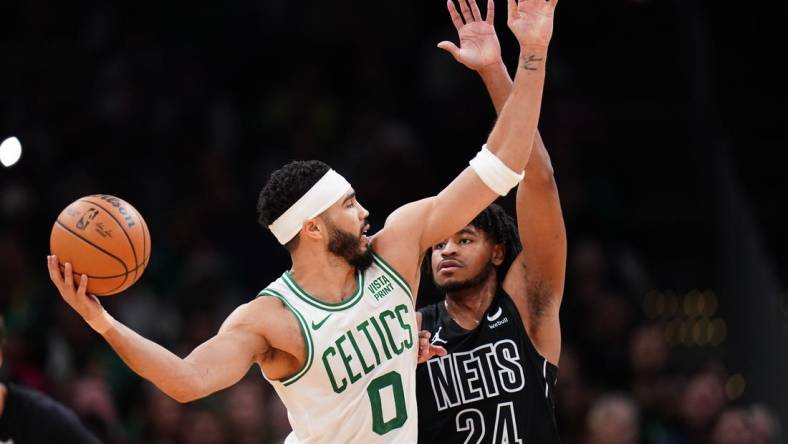 Feb 14, 2024; Boston, Massachusetts, USA; Boston Celtics forward Jayson Tatum (0) looks for an opening against Brooklyn Nets guard Cam Thomas (24) in the second half at TD Garden. Mandatory Credit: David Butler II-USA TODAY Sports