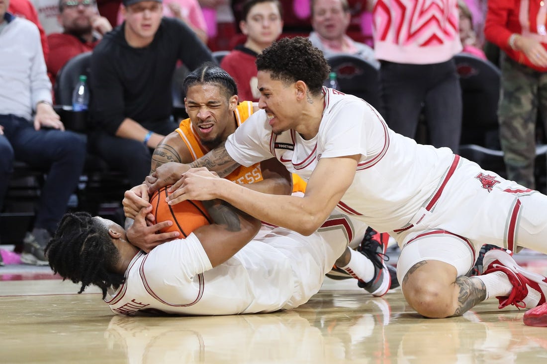 Feb 14, 2024; Fayetteville, Arkansas, USA; Tennessee Volunteers guard Zakai Zeigler (5) fights for a loose ball with Arkansas Razorbacks guard Khalif Battle (0) and forward Jalen Graham (11) during the first half at Bud Walton Arena. Mandatory Credit: Nelson Chenault-USA TODAY Sports