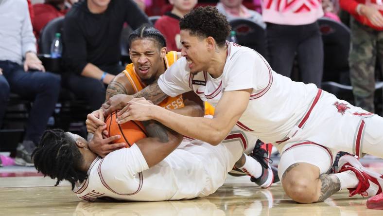 Feb 14, 2024; Fayetteville, Arkansas, USA; Tennessee Volunteers guard Zakai Zeigler (5) fights for a loose ball with Arkansas Razorbacks guard Khalif Battle (0) and forward Jalen Graham (11) during the first half at Bud Walton Arena. Mandatory Credit: Nelson Chenault-USA TODAY Sports