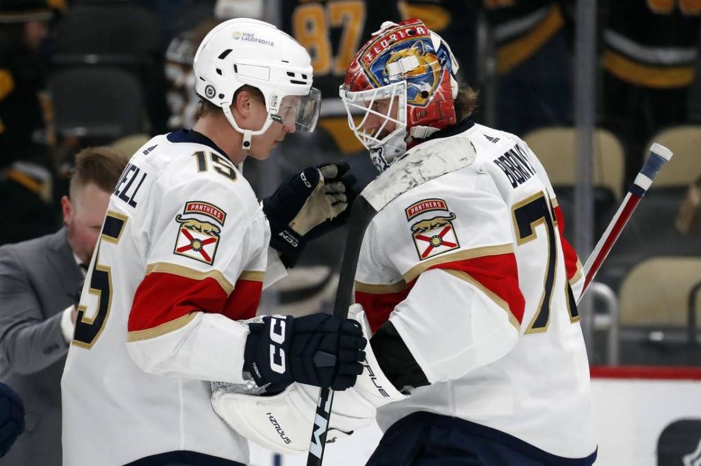 Feb 14, 2024; Pittsburgh, Pennsylvania, USA; Florida Panthers center Anton Lundell (15) and goaltender Sergei Bobrovsky (72) celebrate after defeating the Pittsburgh Penguins at PPG Paints Arena. Florida won 5-2.Mandatory Credit: Charles LeClaire-USA TODAY Sports