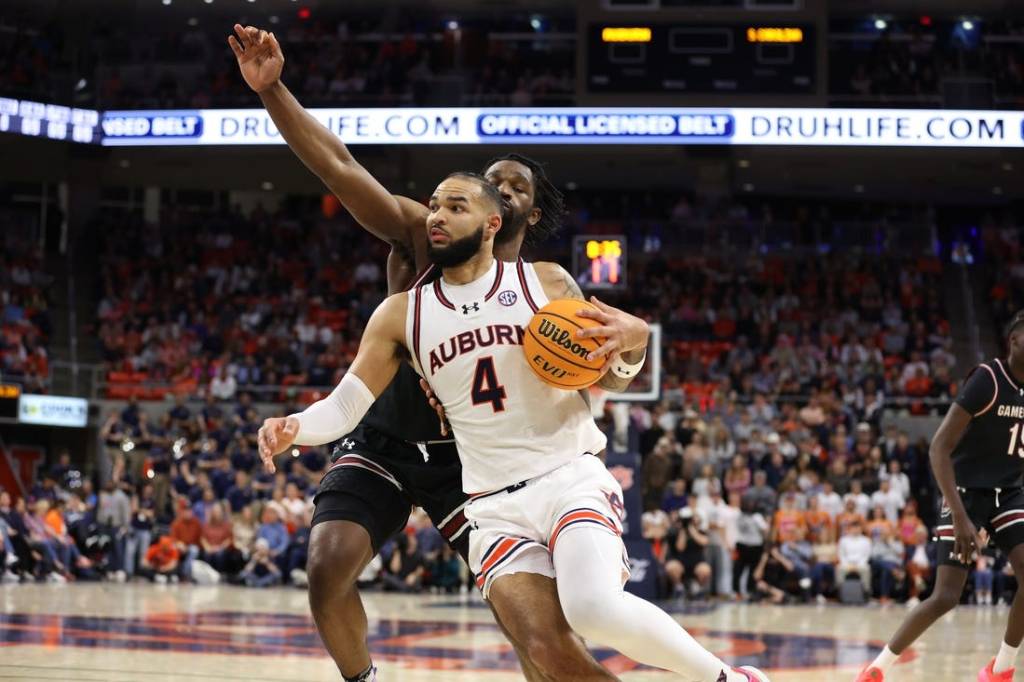 Feb 14, 2024; Auburn, Alabama, USA; Auburn Tigers forward Johni Broome (4) gets past South Carolina Gamecocks forward Josh Gray (33) for a shot during the second half at Neville Arena. Mandatory Credit: John Reed-USA TODAY Sports