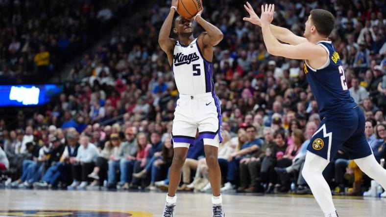 Feb 14, 2024; Denver, Colorado, USA; Sacramento Kings guard De'Aaron Fox (5) shoots the ball over Denver Nuggets guard Collin Gillespie (21) in the second half at Ball Arena. Mandatory Credit: Ron Chenoy-USA TODAY Sports