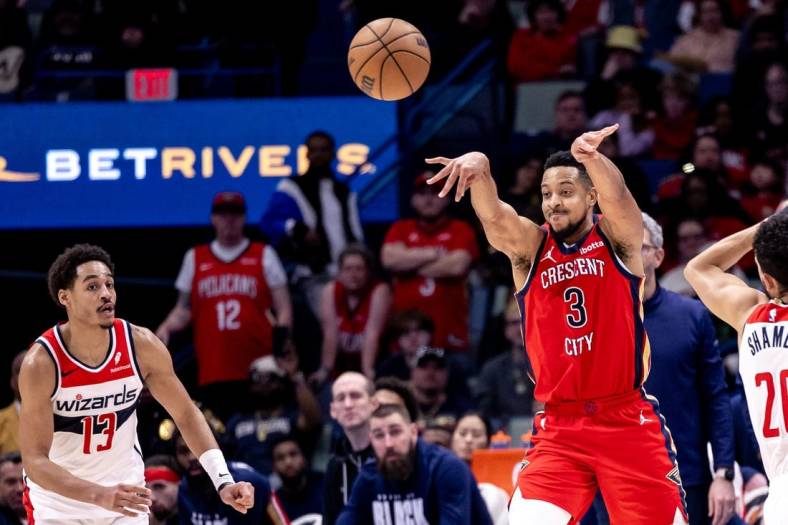 Feb 14, 2024; New Orleans, Louisiana, USA;  New Orleans Pelicans guard CJ McCollum (3) passes the ball against Washington Wizards guard Jordan Poole (13) during the second half at Smoothie King Center. Mandatory Credit: Stephen Lew-USA TODAY Sports