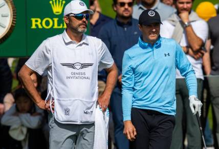 Feb 15, 2024; Pacific Palisades, California, USA; Jordan Spieth and his caddie on the tenth hole during the first round of The Genesis Invitational golf tournament. Mandatory Credit: Jason Parkhurst-USA TODAY Sports