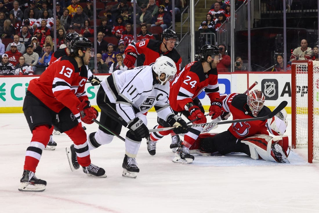 Feb 15, 2024; Newark, New Jersey, USA; New Jersey Devils goaltender Nico Daws (50) makes a glove save on Los Angeles Kings center Anze Kopitar (11) during the first period at Prudential Center. Mandatory Credit: Ed Mulholland-USA TODAY Sports