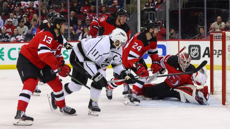 Feb 15, 2024; Newark, New Jersey, USA; New Jersey Devils goaltender Nico Daws (50) makes a glove save on Los Angeles Kings center Anze Kopitar (11) during the first period at Prudential Center. Mandatory Credit: Ed Mulholland-USA TODAY Sports