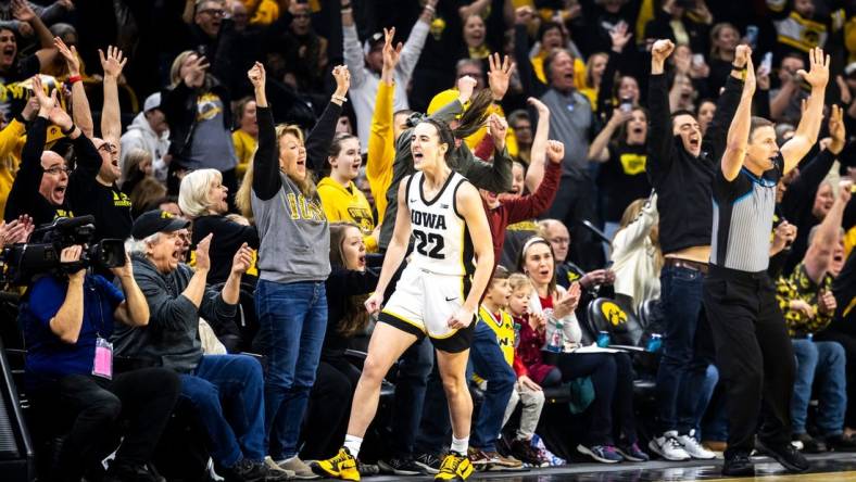 Iowa guard Caitlin Clark (22) reacts after making a 3-point basket setting the record for all-time leading scoring during a NCAA Big Ten Conference women's basketball game against Michigan, Thursday, Feb. 15, 2024, at Carver-Hawkeye Arena in Iowa City, Iowa.